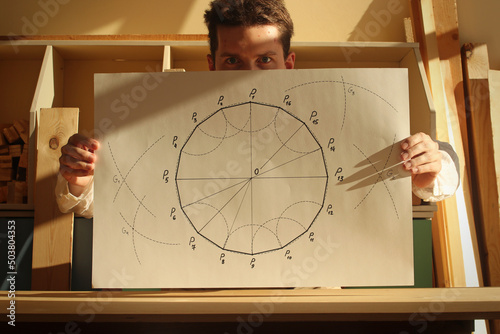 Fotomural Young mathematician and designer and his drawing regular hexadecagon on the paper