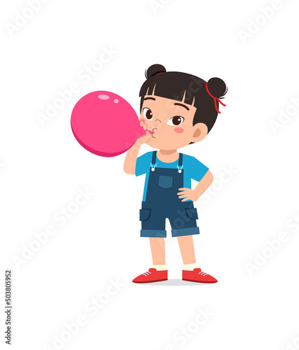 little kid standing and blowing a balloon