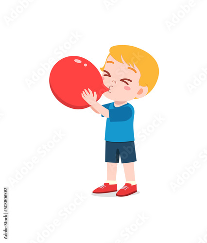 little kid standing and blowing a balloon
