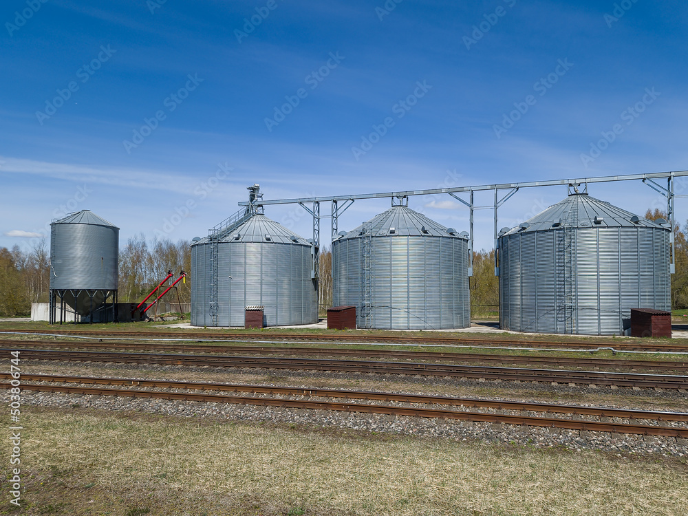 Modern Granary elevator. Silver silos on agro-processing and manufacturing plant for processing drying cleaning and storage of agricultural products, flour, cereals and grain. Modern Granary elevator. Silver silos on agro-processing and manufacturing plant for processing drying cleaning and storage of agricultural products, flour, cereals and grain.
