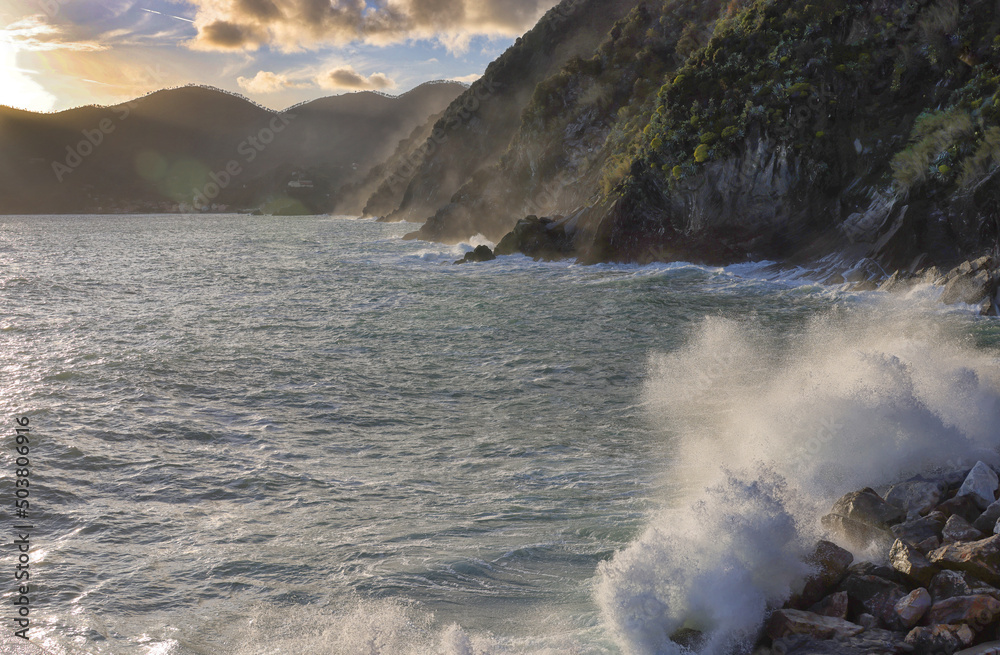 Rocks and waves in sunset light on the sea near Cinque Terre - Vernazza, in the province of La Spezia, Liguria, Italy, Europe Rocks and waves in sunset light on the sea near Cinque Terre - Vernazza, in the province of La Spezia, Liguria, Italy, Europe