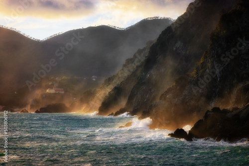 Rocks and waves on the sea near Cinque Terre - Manarola, picturesque fishermen villages in the province of La Spezia, Liguria, Italy