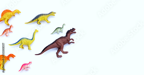 Plastic dinosaur toys on white background. Top view photo