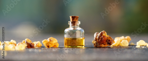 A bottle of frankincense essential oil with frankincense resin - panoramic header