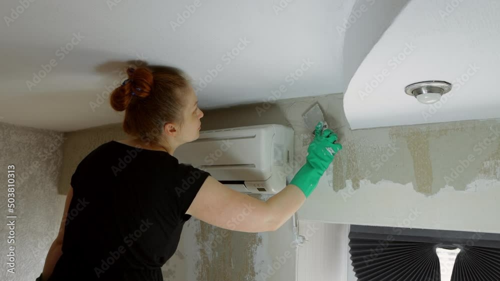 a woman puts plaster on drywall walls, self-repair of the interior a woman puts plaster on drywall walls, self-repair of the interior