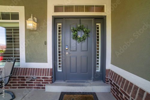 Closeup shot of a blue front door decorated with a holiday wreath photo