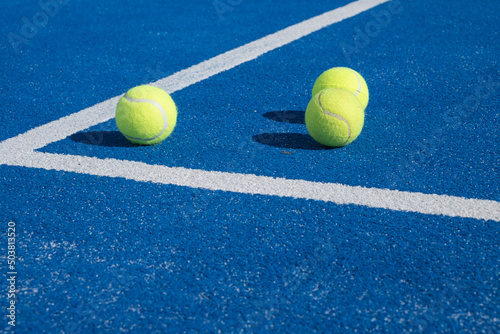 three balls on a paddle tennis court, selective focus,  © VicVaz