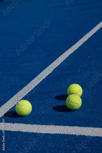 Three balls an the net of a paddle tennis court. Selective focus. © Vic