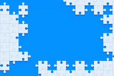 Unfinished blank jigsaw puzzle pieces on blue background. Copy space. Top view. 3d render