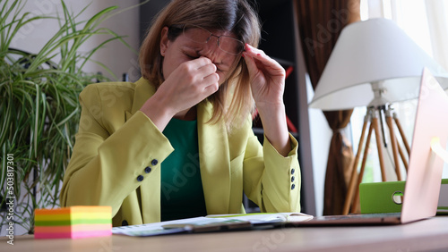 Tableau sur toile Tired business woman takes off glasses, feeling tired eyes from working at compu