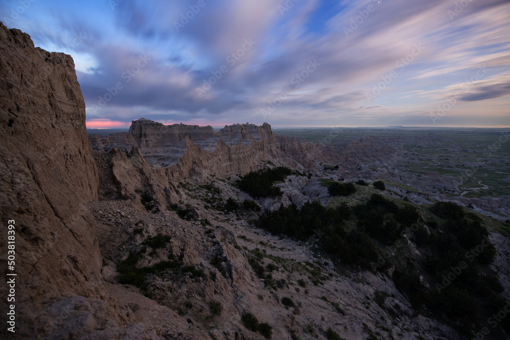 Color moonset / sunrise in the hills of Badlands National Park