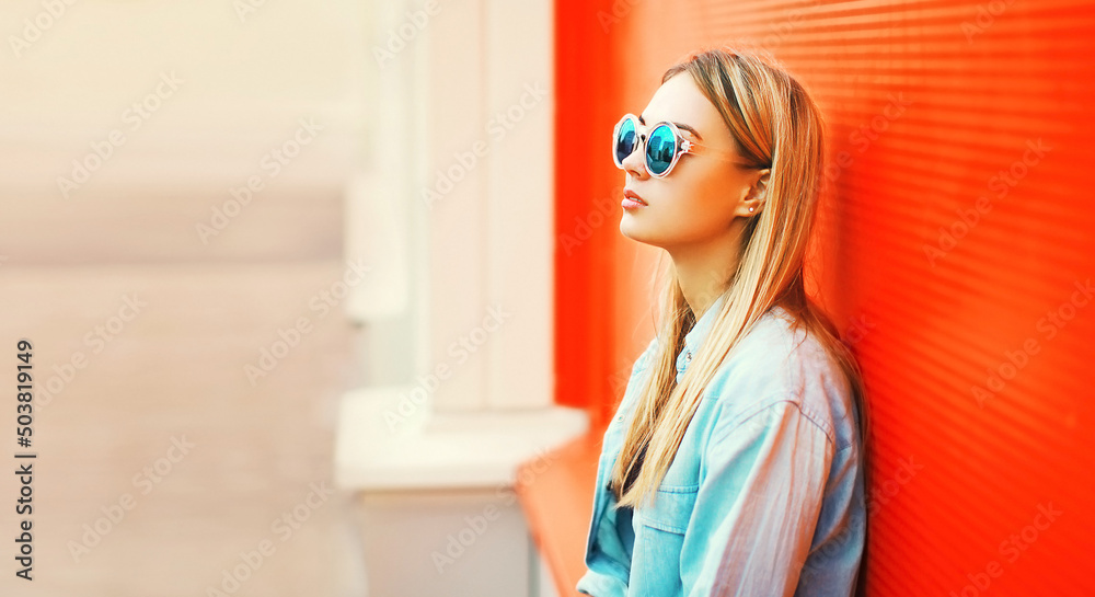 Summer portrait of beautiful blonde young woman wearing sunglasses, shirt in the city Summer portrait of beautiful blonde young woman wearing sunglasses, shirt in the city