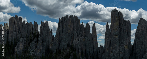 A pair of rock climbers atop a massive spire in Custer State Par