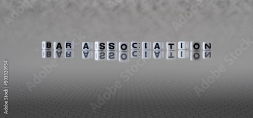 bar association word or concept represented by black and white letter cubes on a grey horizon background stretching to infinity