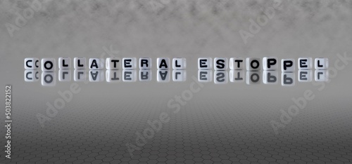 collateral estoppel word or concept represented by black and white letter cubes on a grey horizon background stretching to infinity photo