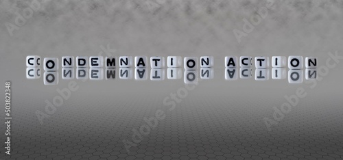 condemnation action word or concept represented by black and white letter cubes on a grey horizon background stretching to infinity