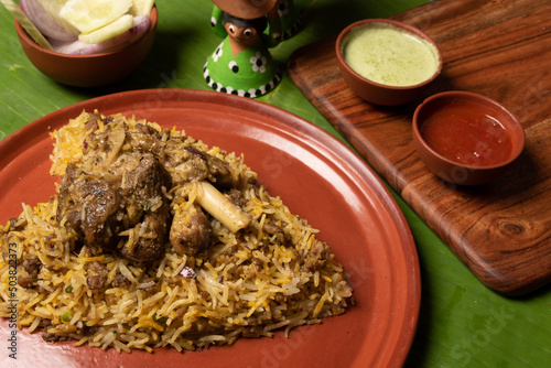 Shot of the spicy hot mutton biryani served in a brown plate