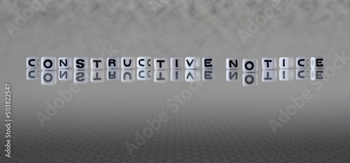 Fotografi constructive notice word or concept represented by black and white letter cubes