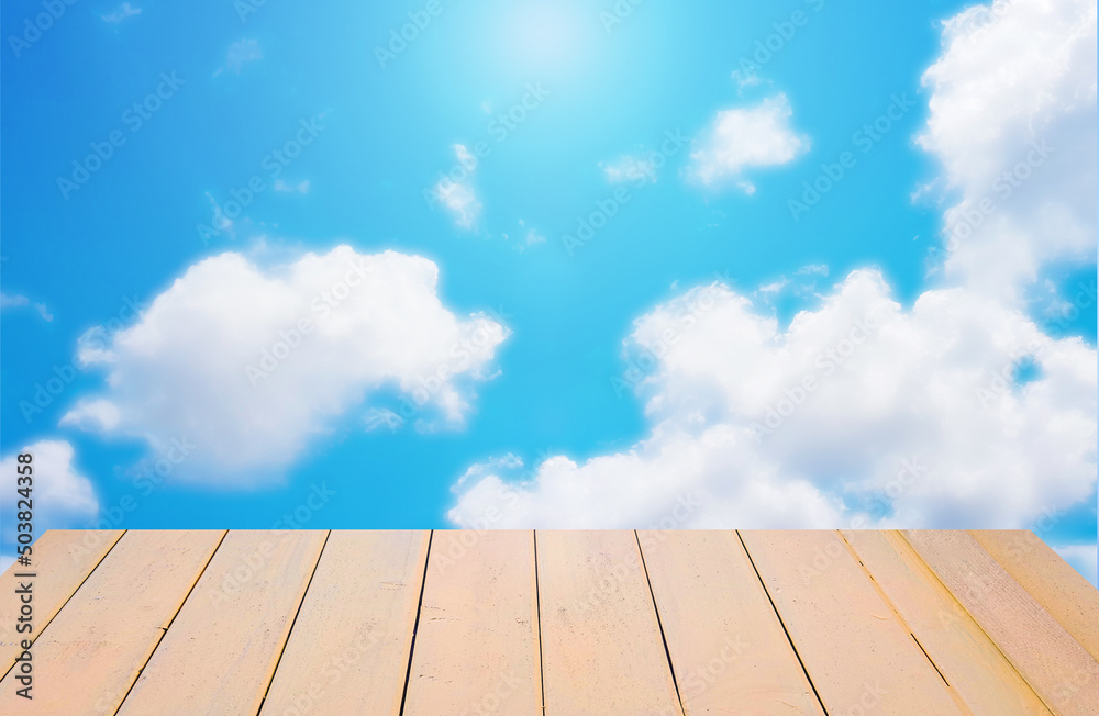 Empty table on blue cloudy sky background
