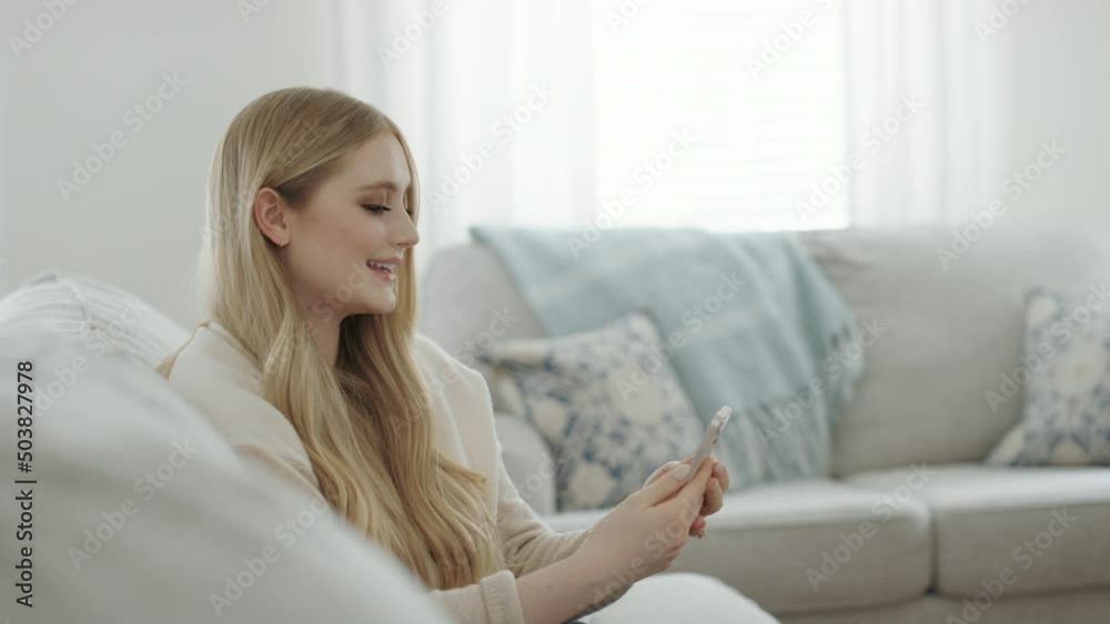 Profile view beautiful blonde woman at home video chats on phone slow motion Profile view beautiful blonde woman at home video chats on phone slow motion
