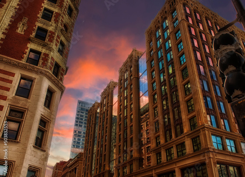 View of city buildings and the sunset dramatic sky on the streets of Boston. USA. Massachusetts.
