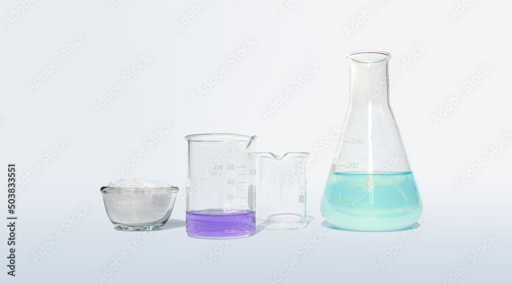 Microcrystalline wax in glass container glass place next to Potassium Permanganate Liquid in beaker and Iron (II) sulfate liquid in Erlenmeyer flask. Side View Microcrystalline wax in glass container glass place next to Potassium Permanganate Liquid in beaker and Iron (II) sulfate liquid in Erlenmeyer flask. Side View