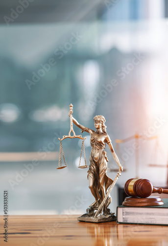 Legal and law concept. Statue of Lady Justice with scales of justice and wooden judge gavel on wooden table. Panoramic image statue of lady justice. photo