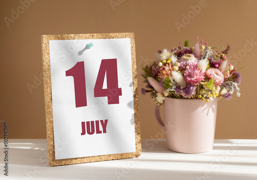 Wallpaper Mural july 14. 14th day of month, calendar date.Bouquet of dead wood in pink mug on desktop.Cork board with calendar sheet on white-beige background. Concept of day of year, time planner, summer month Torontodigital.ca