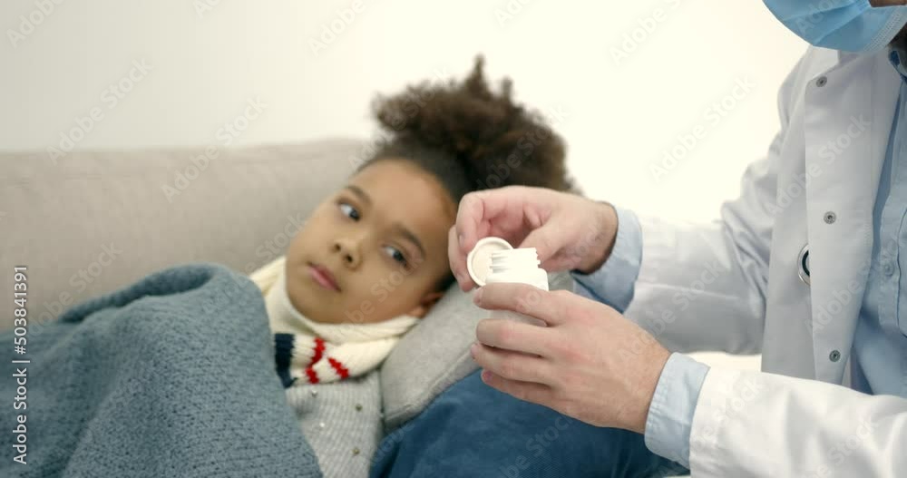 Pediatrician at home visiting helping little black girl