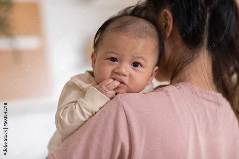 Thumbs or fingers sucking in baby newborn habit for calm and relax. Asian infant baby open mouth and putting fingers in to sucking feel secure.Baby newborn habit concept Thumbs or fingers sucking in baby newborn habit for calm and relax. Asian infant baby open mouth and putting fingers in to sucking feel secure.Baby newborn habit concept
