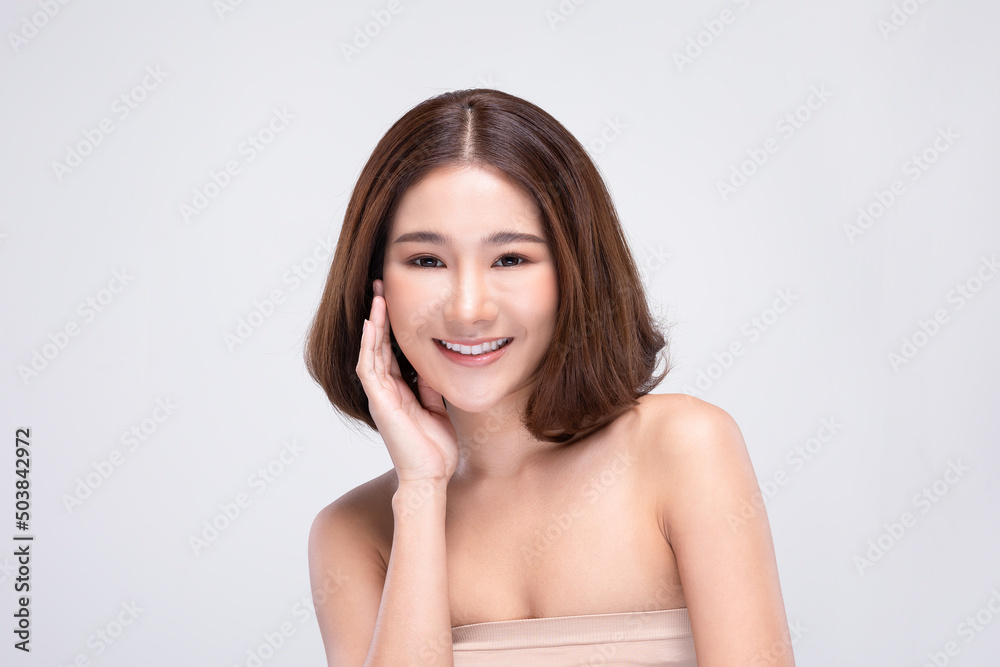 Beautiful Asian young woman with short hairs touching soft cheek smile with clean and fresh skin Happiness and cheerful with positive emotional isolated on white background.Beauty Cosmetics Concept Beautiful Asian young woman with short hairs touching soft cheek smile with clean and fresh skin Happiness and cheerful with positive emotional isolated on white background.Beauty Cosmetics Concept