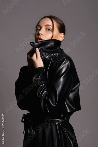 Beautiful woman in leather trench coat. beauty passion brunette girl photo