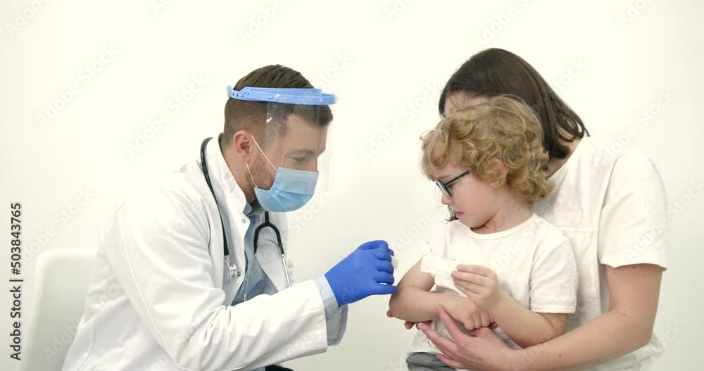 Mother with kids vaccinating at pediatrician office Mother with kids vaccinating at pediatrician office