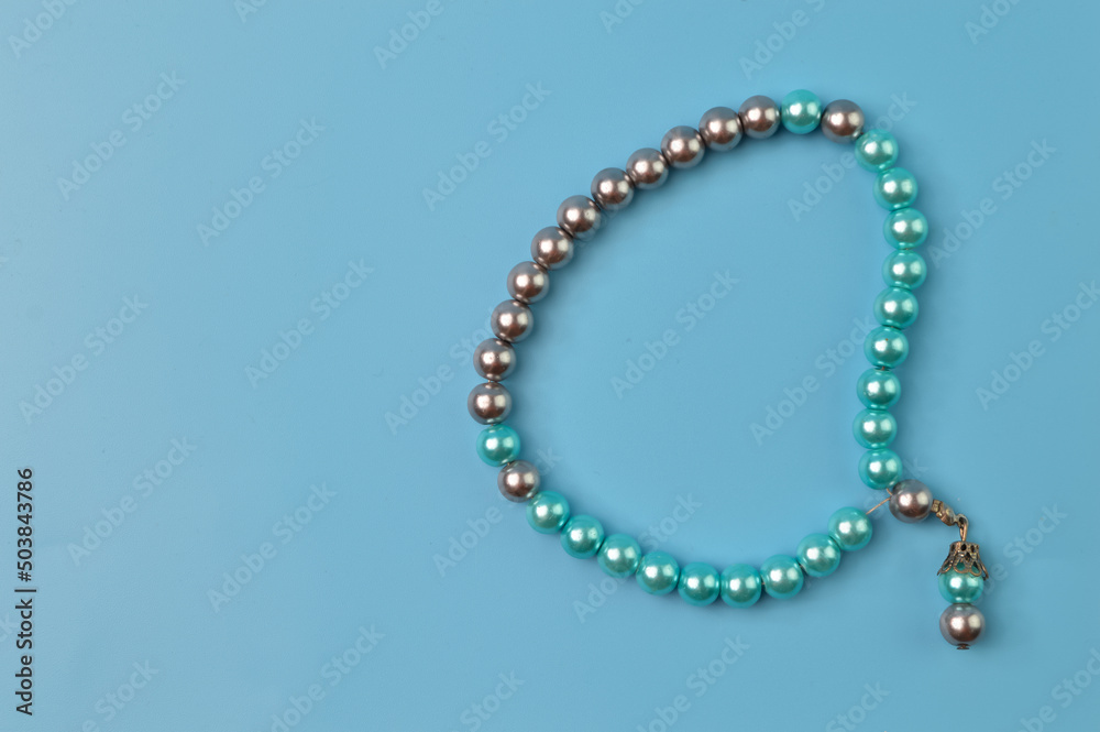 Pearls bracelet isolated on a blue background Pearls bracelet isolated on a blue background