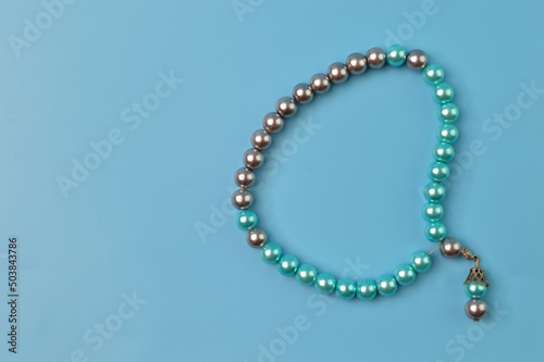 Pearls bracelet isolated on a blue background