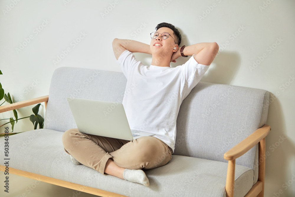 A moment of young working with laptop at home in living room background A moment of young working with laptop at home in living room background
