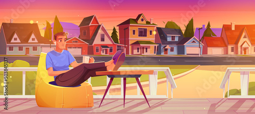 Man rest on wooden house porch in suburban street. Vector cartoon illustration of person sitting in bean bag chair with cup and earbuds on terrace and view of cottages at sunset