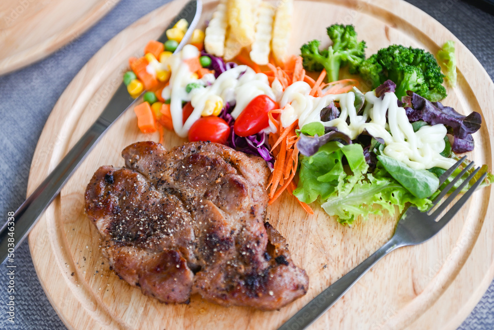 Steak homemade with french fries and fresh vegetable salad on wooden tray, healthy steak menu, Steak pork