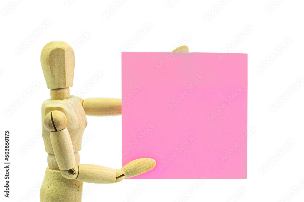 Wooden human dummy manikin with moveable limbs pose holding paper on a white background Wooden human dummy manikin with moveable limbs pose holding paper on a white background