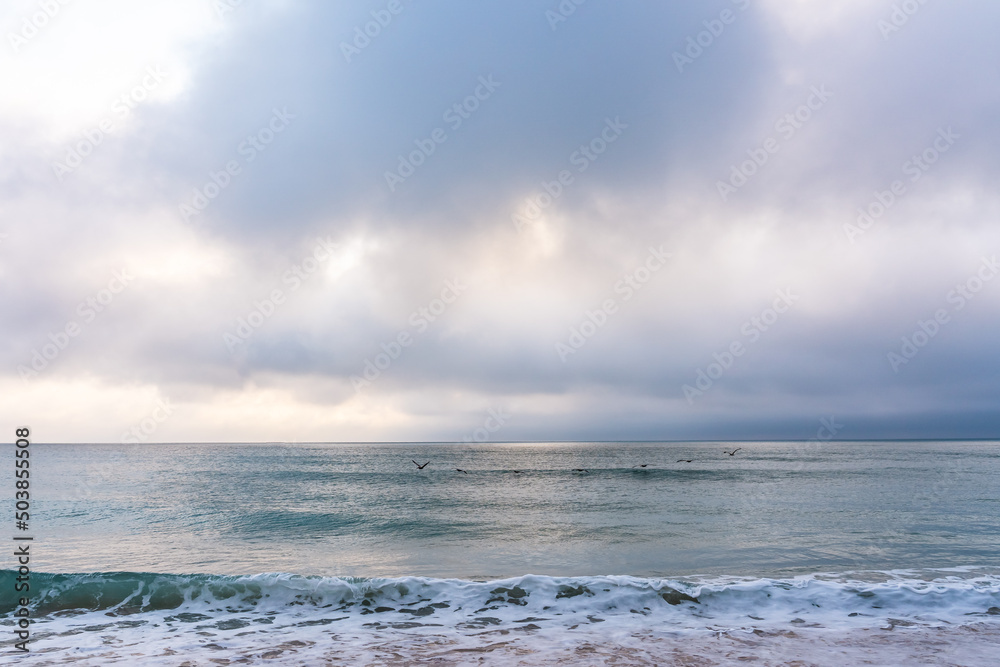 View of the Atlantic Ocean in calm cloudy weather in Florida. Atmosphere of rest, relaxation, tranquility