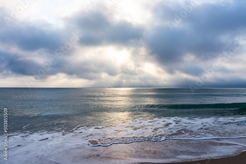 Sunrise over the Atlantic Ocean in Florida. Calm water  leaden ocean  lush clouds. Soothing view  relaxation