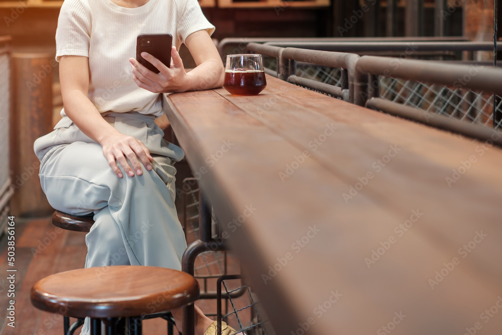 Casual Businesswoman holding and using smartphone for sms messages, young woman typing touchscreen mobile phone in coffee cafe or modern office. lifestyle, technology, Social media and network concept