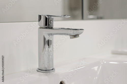 A closeup shot basin mixer tap for the bathtub in the bathroom.