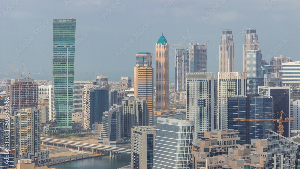 Skyline with modern architecture of Dubai business bay towers timelapse. Aerial view