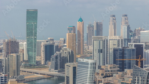 Skyline with modern architecture of Dubai business bay towers timelapse. Aerial view