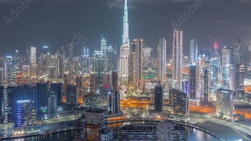 Panoramic skyline of Dubai with business bay and downtown district night timelapse. photo