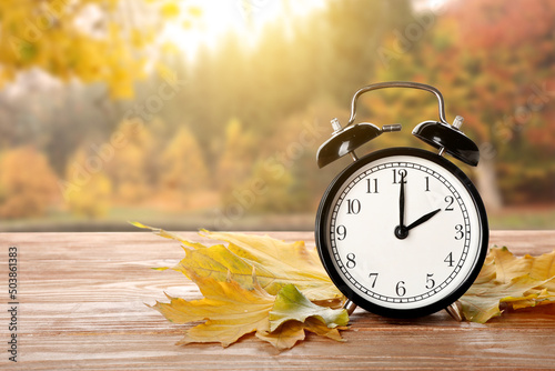 Alarm clock and autumn leav...