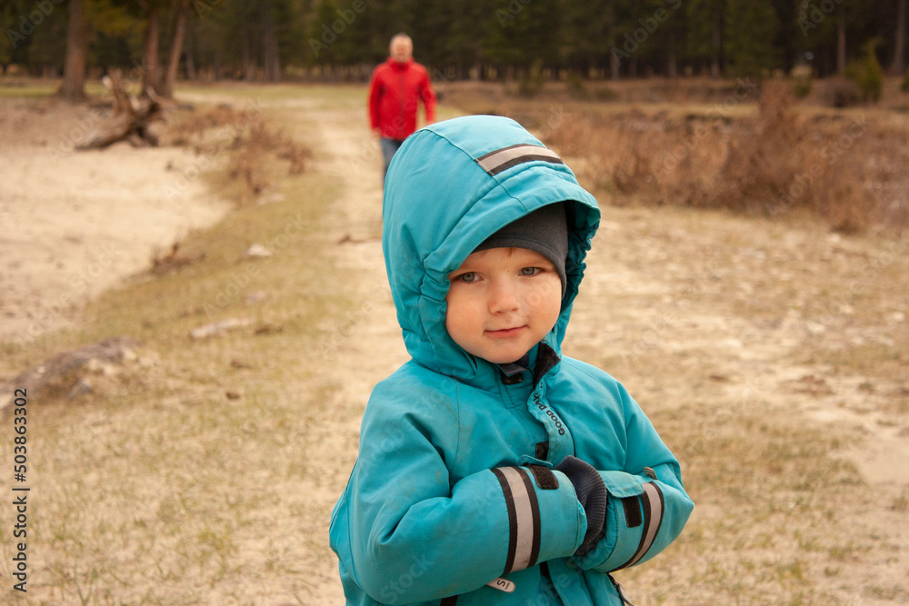 A man with a backpack, a father and his son on a hike, walking during walks in the woods. Family life, pastime with the family, the upbringing of children. A man with a backpack, a father and his son on a hike, walking during walks in the woods. Family life, pastime with the family, the upbringing of children.