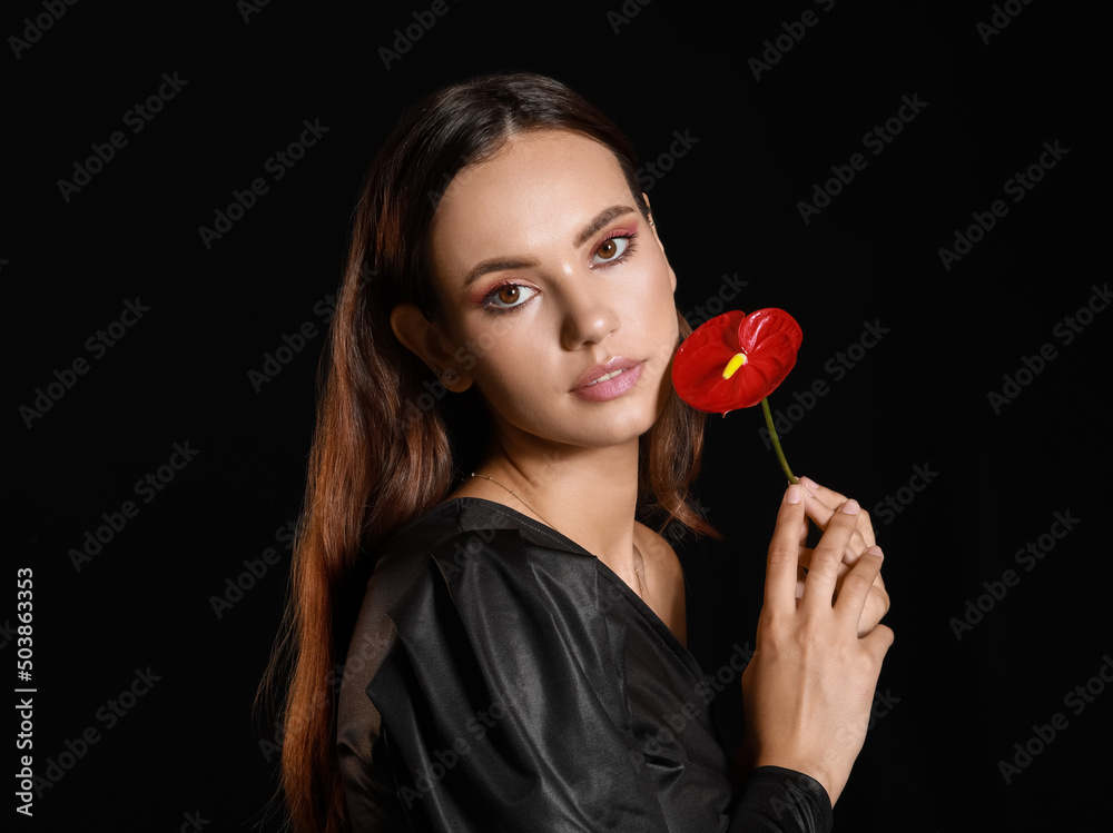 Portrait of elegant woman with beautiful anthurium flower on black background Portrait of elegant woman with beautiful anthurium flower on black background