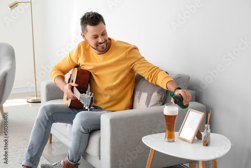 Handsome man drinking beer ...